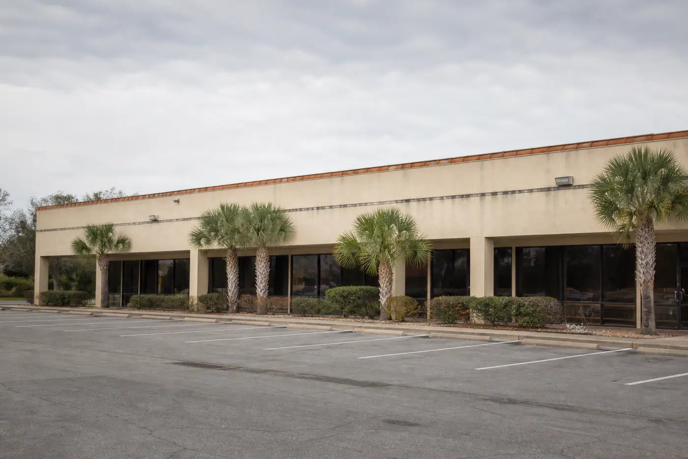 A small Central Florida strip plaza with staining along the roof fascia after a commercial property loss.